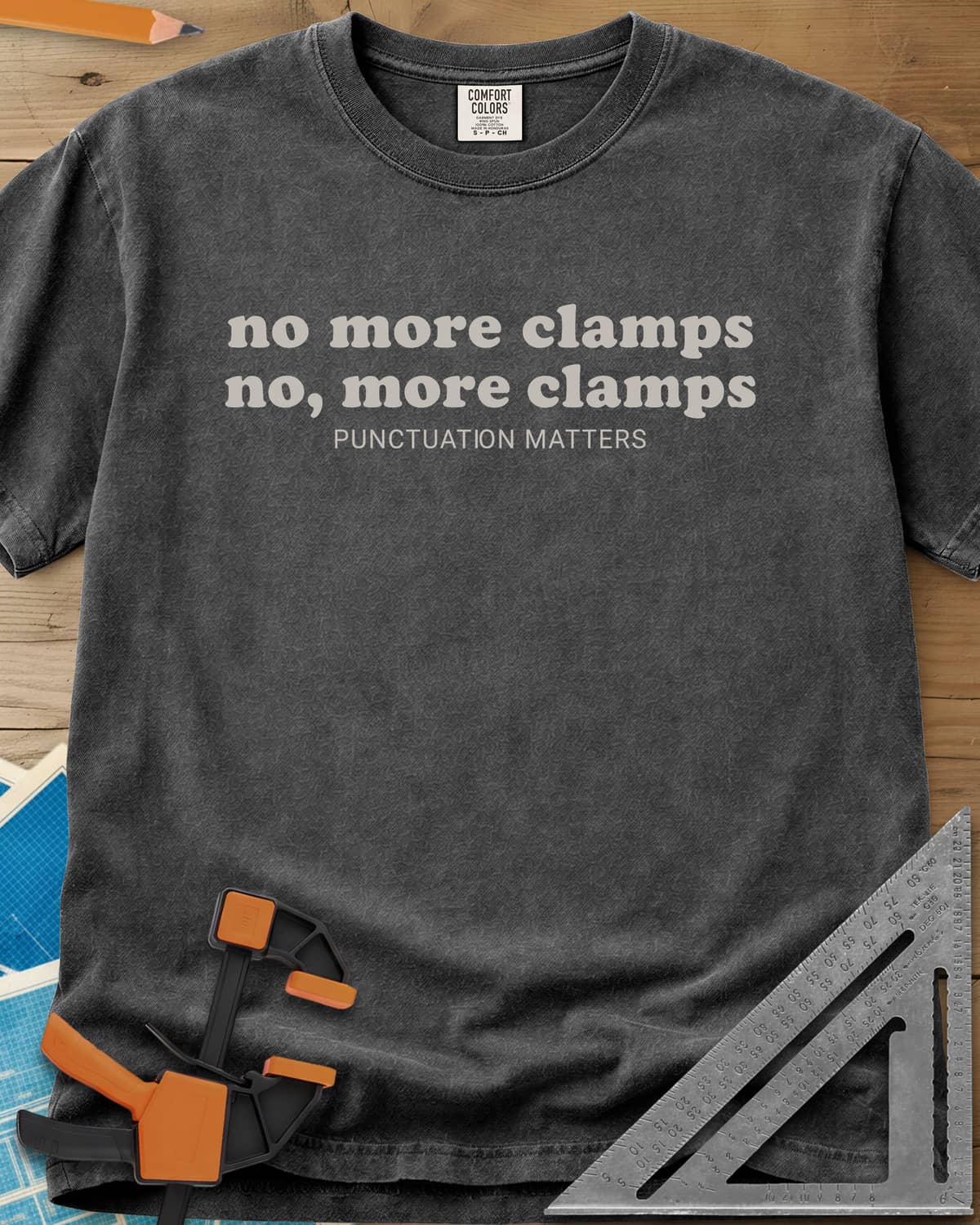 No More Clamps Punctuation Matters heavyweight tee in Pepper, two lowercase retro lines that differ by a comma, tagline below