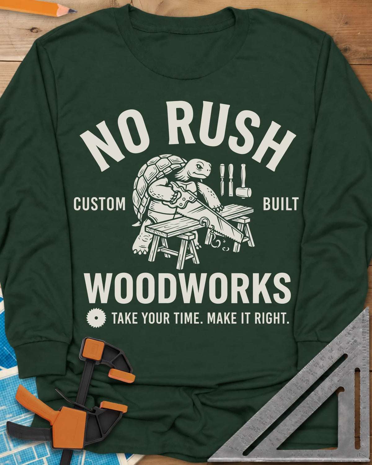 No Rush Woodworks long sleeve shirt in Forest Green, a tortoise sawing a board on sawhorses inside a woodshop badge