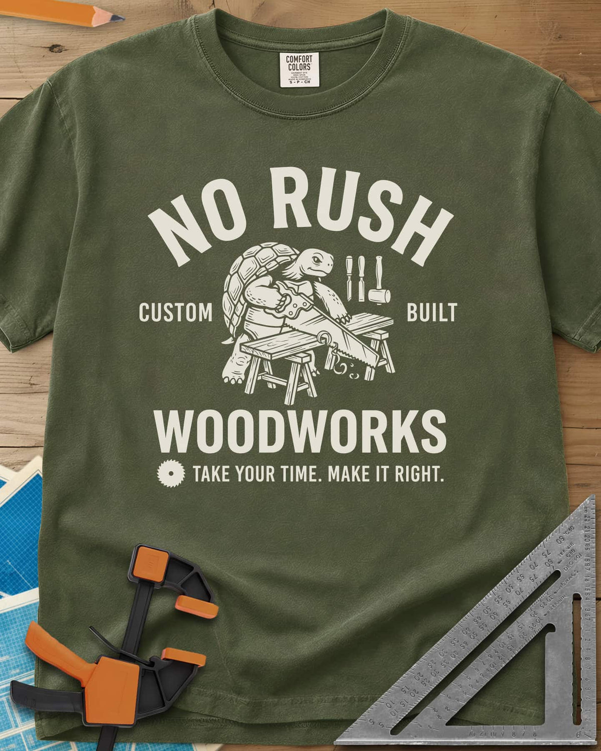No Rush Woodworks heavyweight tee in Hemp, a tortoise sawing a board on sawhorses inside a woodshop badge