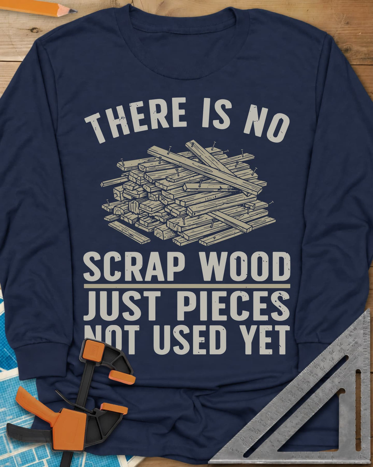 No Scrap Wood long sleeve shirt in Navy, a tall pile of offcut boards with a few nails sticking out