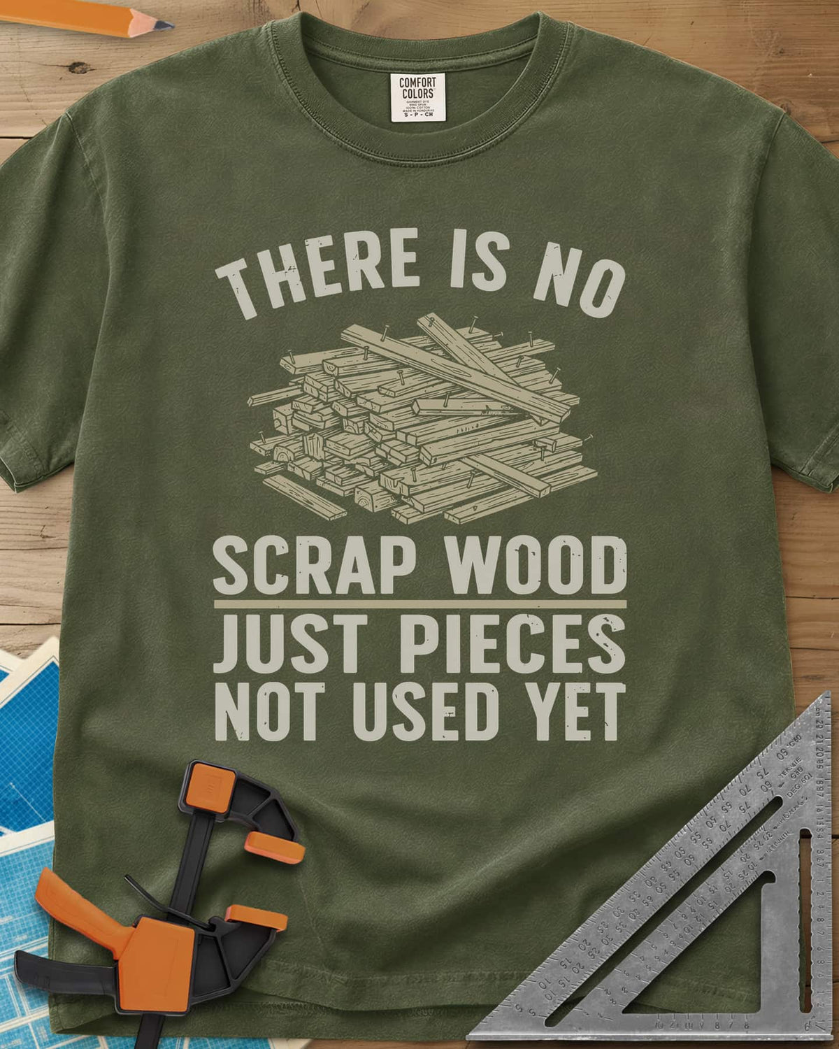 No Scrap Wood heavyweight tee in Hemp, a tall pile of offcut boards with a few nails sticking out