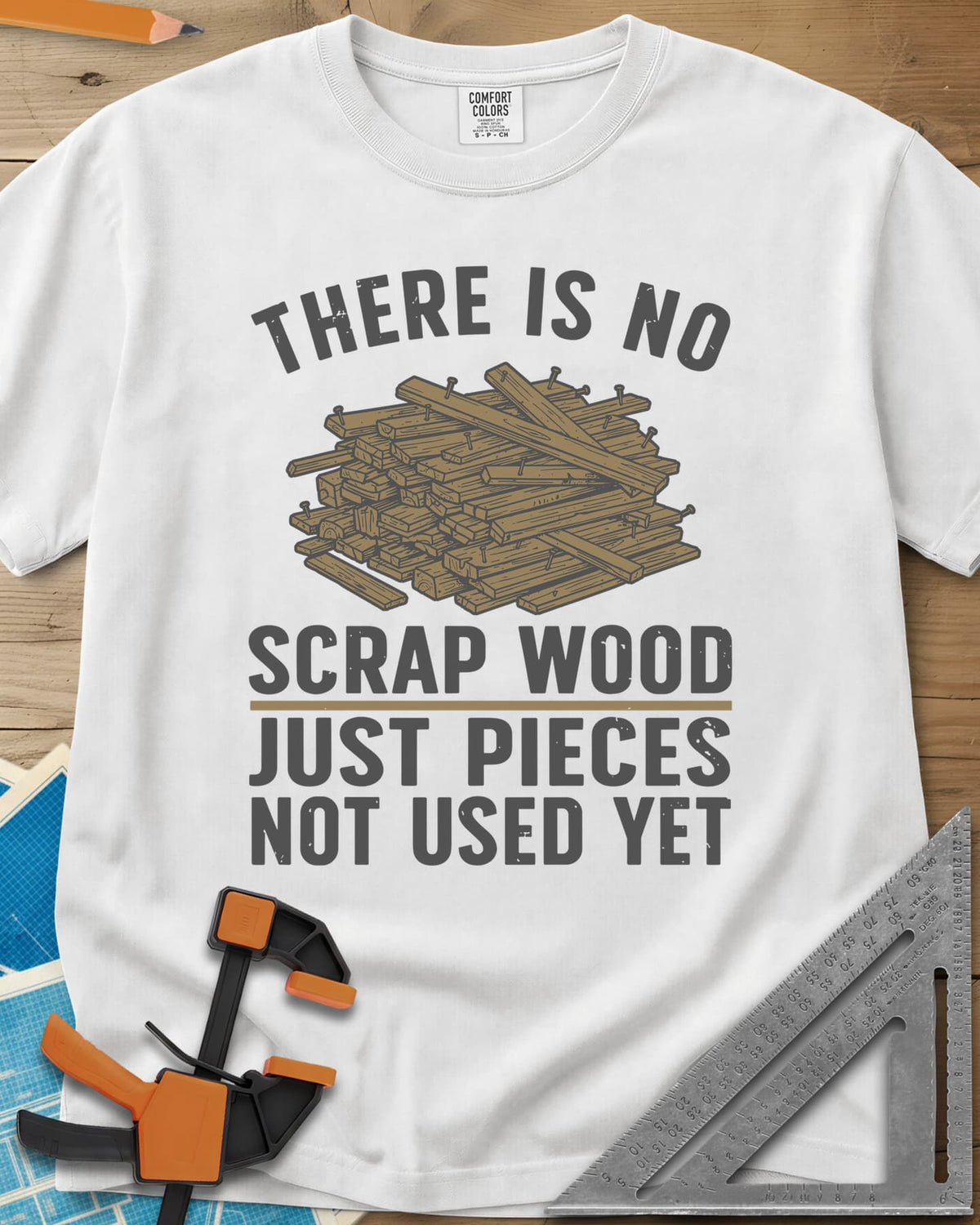 No Scrap Wood heavyweight tee in White, a tall pile of offcut boards with a few nails sticking out
