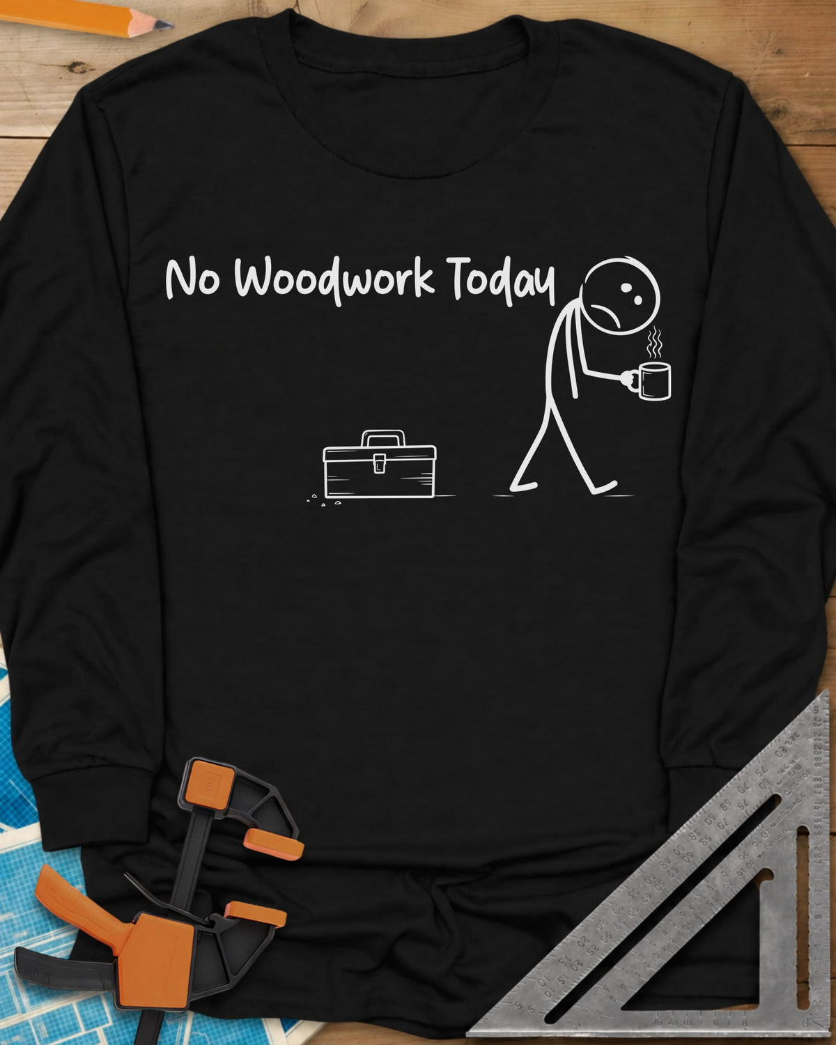 No Woodwork Today long sleeve shirt in Black, a sad stick figure with a mug walking past a closed toolbox