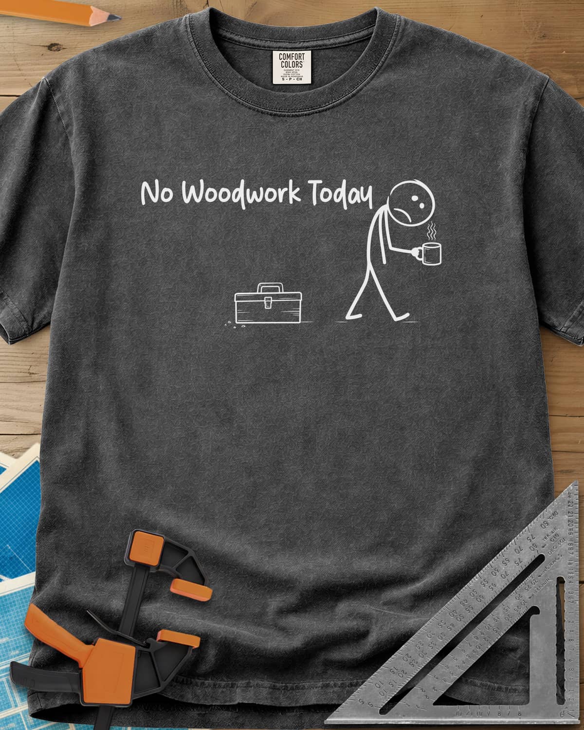 No Woodwork Today heavyweight tee in Pepper, a sad stick figure with a mug walking past a closed toolbox