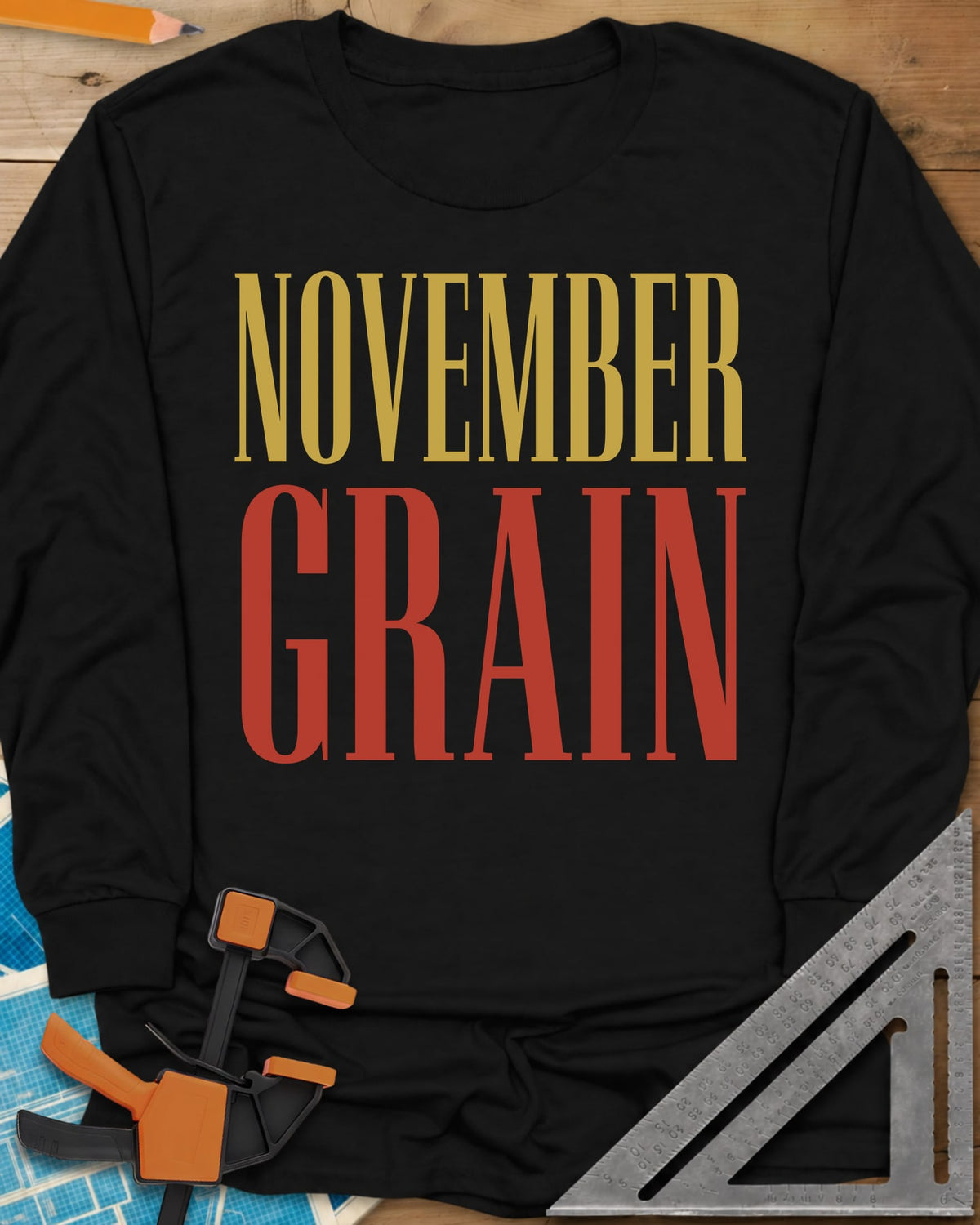 November Grain long sleeve shirt in Black, tall serif capitals, gold NOVEMBER over red GRAIN