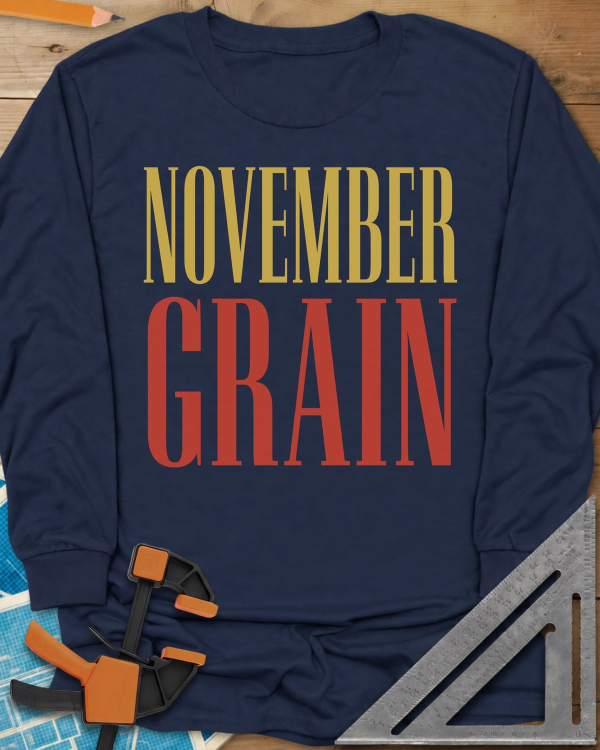 November Grain long sleeve shirt in Navy, tall serif capitals, gold NOVEMBER over red GRAIN