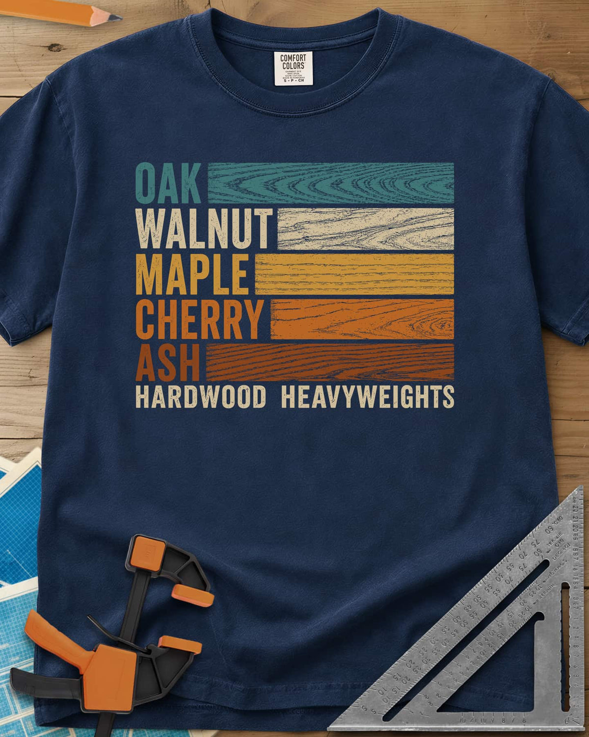 Oak Walnut Maple Cherry Ash heavyweight tee in Navy, five wood names beside strips of their own grain in retro colors