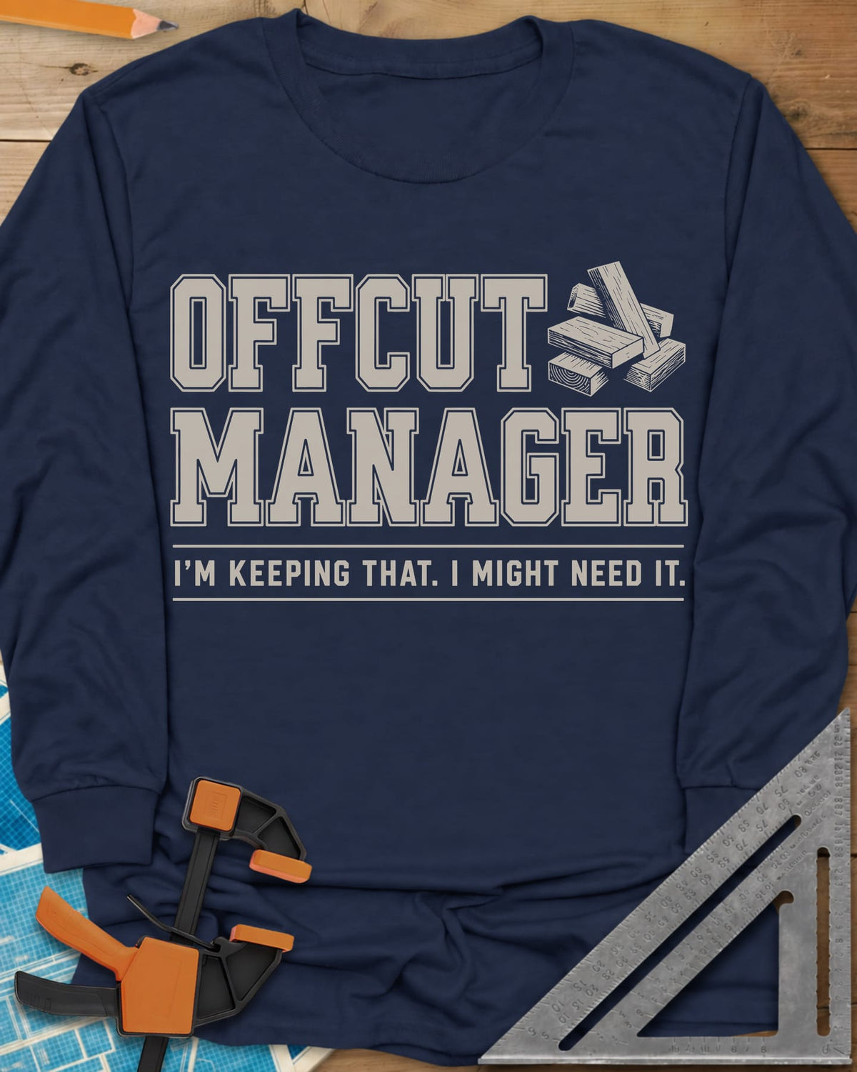 Offcut Manager long sleeve shirt in Navy, varsity block lettering beside a little stack of wood offcuts