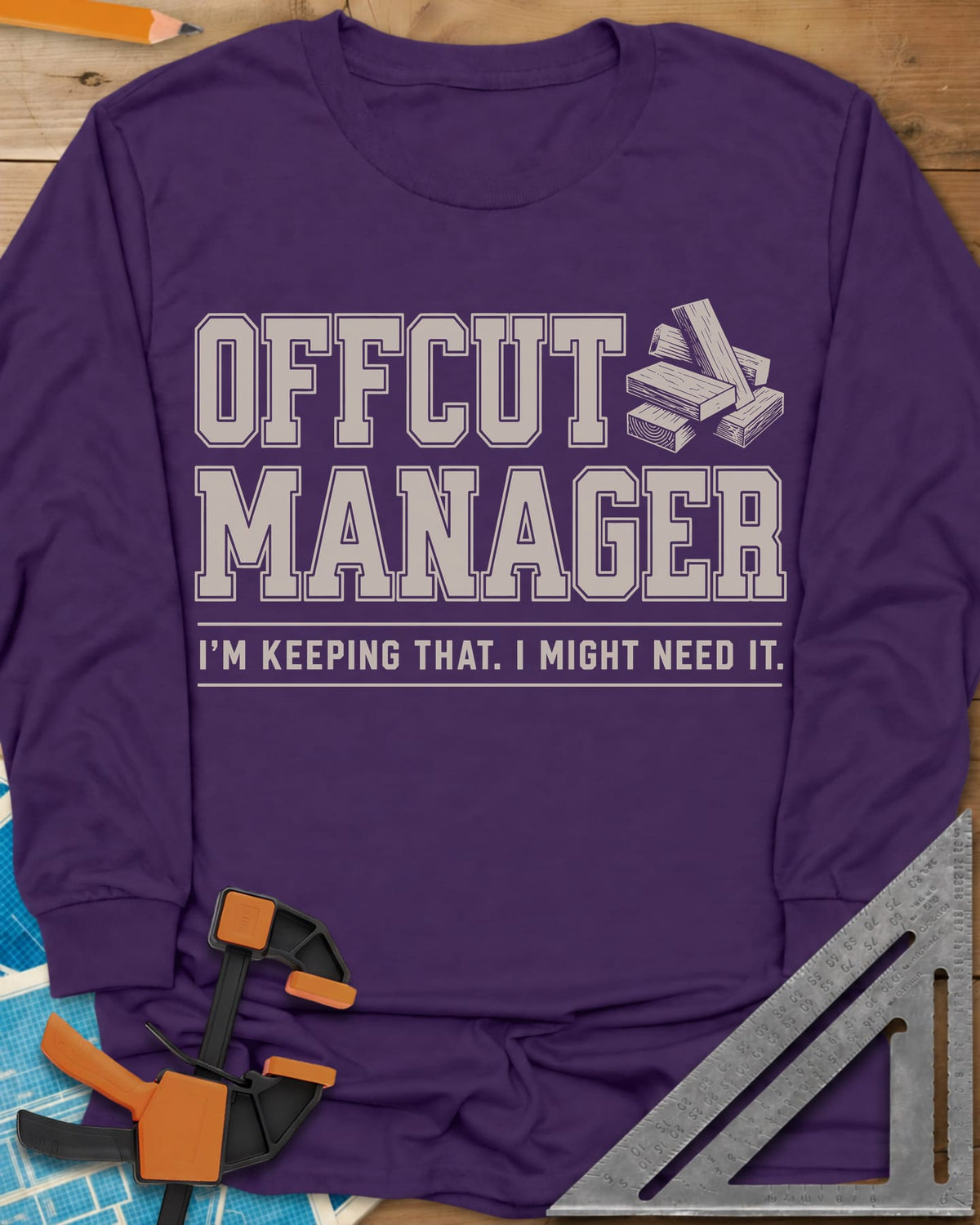 Offcut Manager long sleeve shirt in Purple, varsity block lettering beside a little stack of wood offcuts
