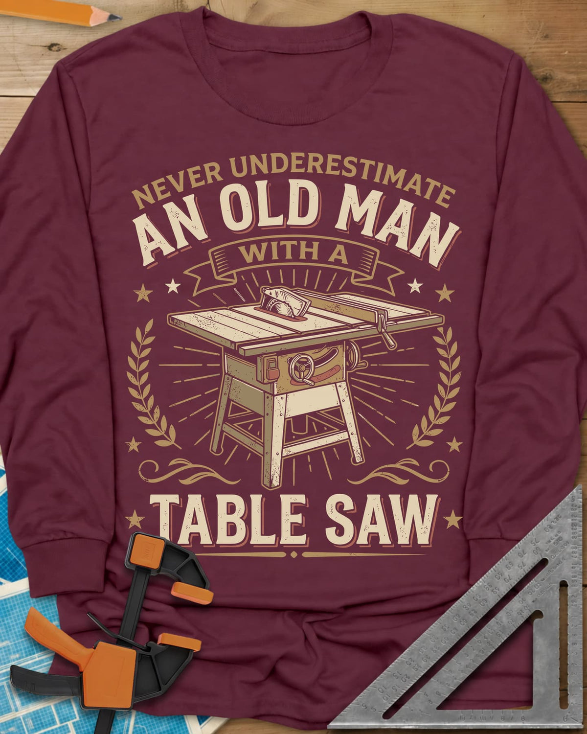 Old Man With A Table Saw long sleeve shirt in Maroon, a cabinet table saw in a laurel and star badge with a banner