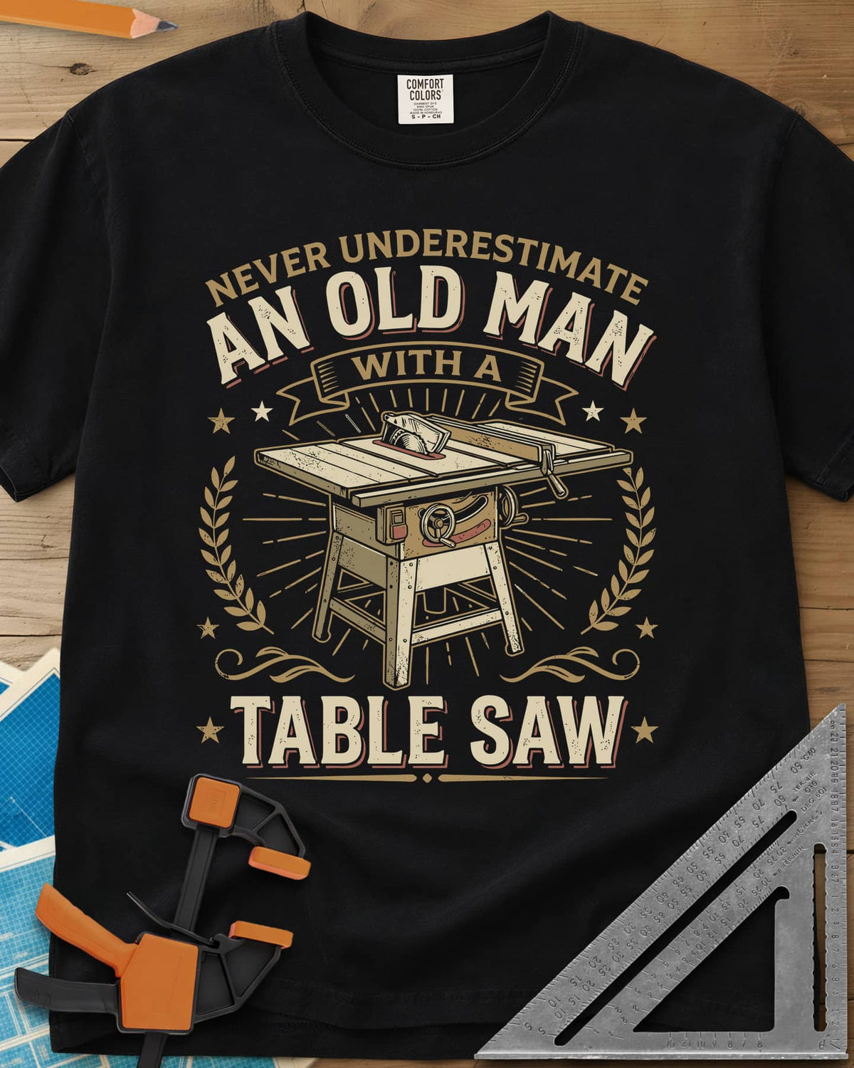 Old Man With A Table Saw heavyweight tee in Black, a cabinet table saw in a laurel and star badge with a banner
