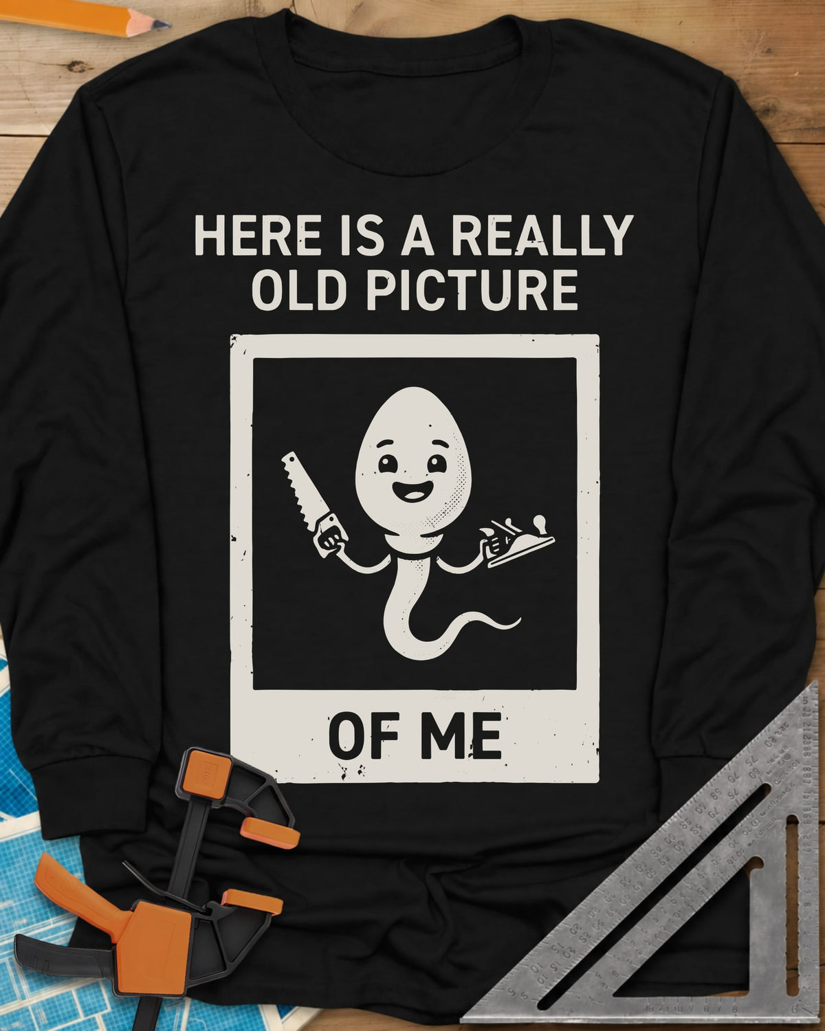 Old Picture long sleeve shirt in Black, a smiling cartoon figure with a long tail holding a saw and a plane