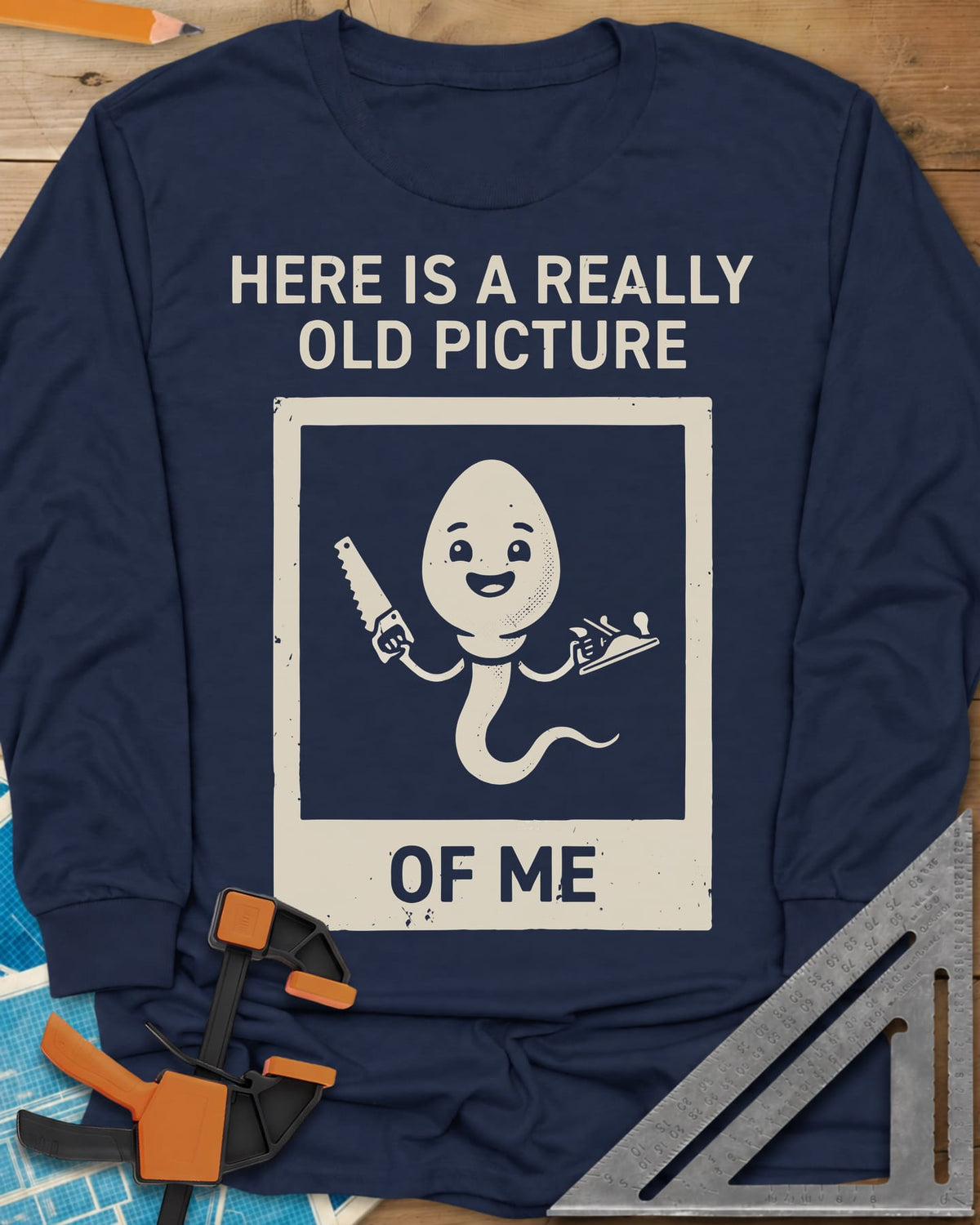 Old Picture long sleeve shirt in Navy, a smiling cartoon figure with a long tail holding a saw and a plane