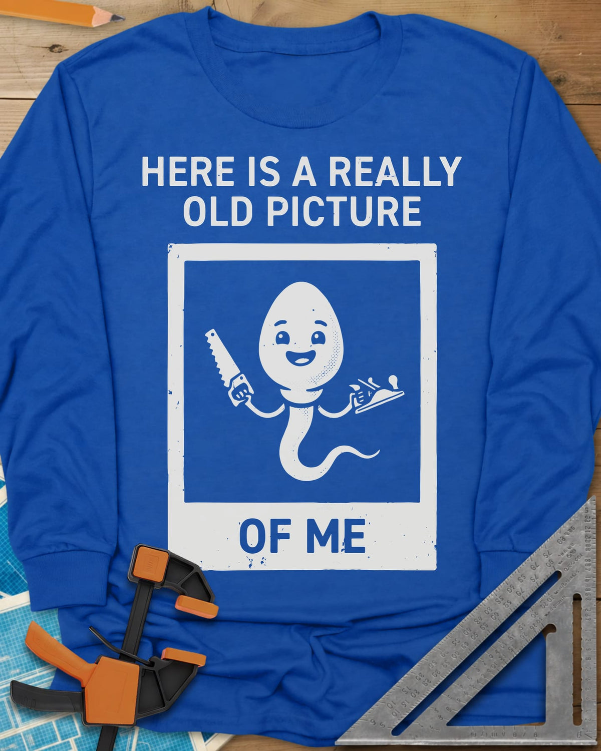 Old Picture long sleeve shirt in Royal, a smiling cartoon figure with a long tail holding a saw and a plane