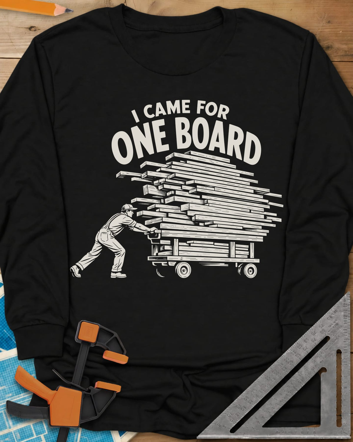 One Board Haul long sleeve shirt in Black, a man pushing a flatbed cart piled high with lumber