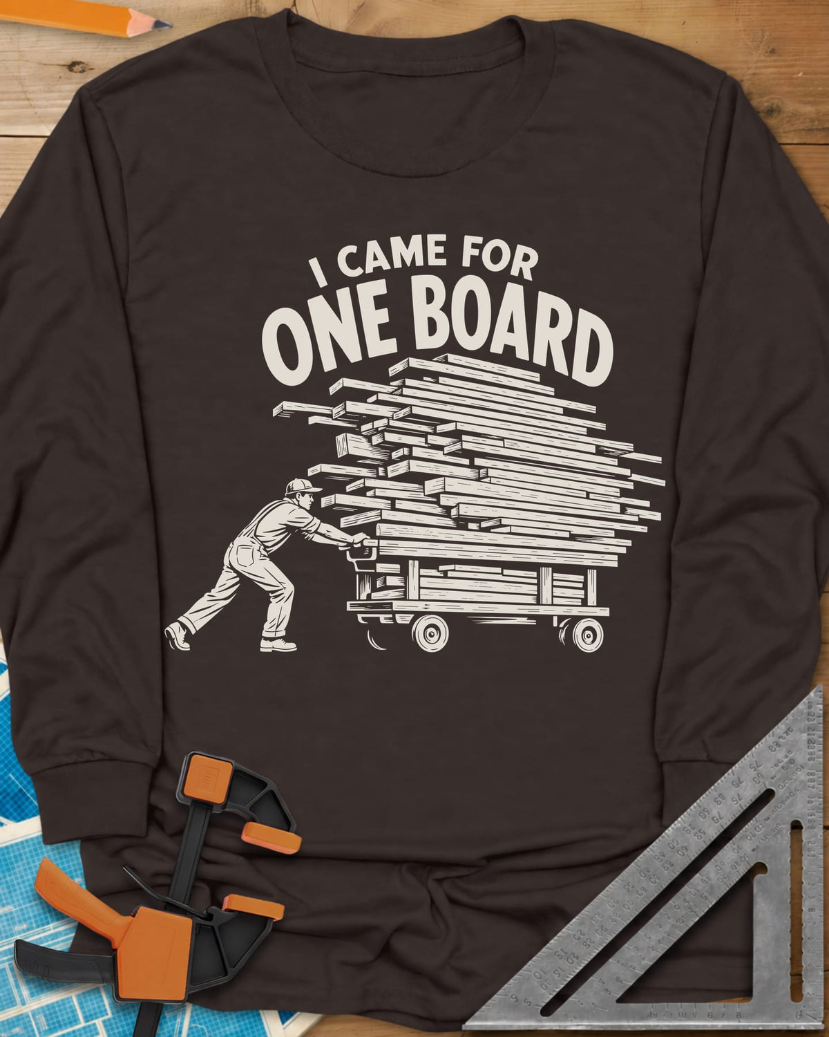 One Board Haul long sleeve shirt in Dark Chocolate, a man pushing a flatbed cart piled high with lumber