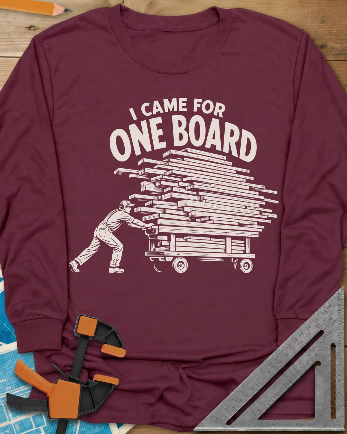 One Board Haul long sleeve shirt in Maroon, a man pushing a flatbed cart piled high with lumber