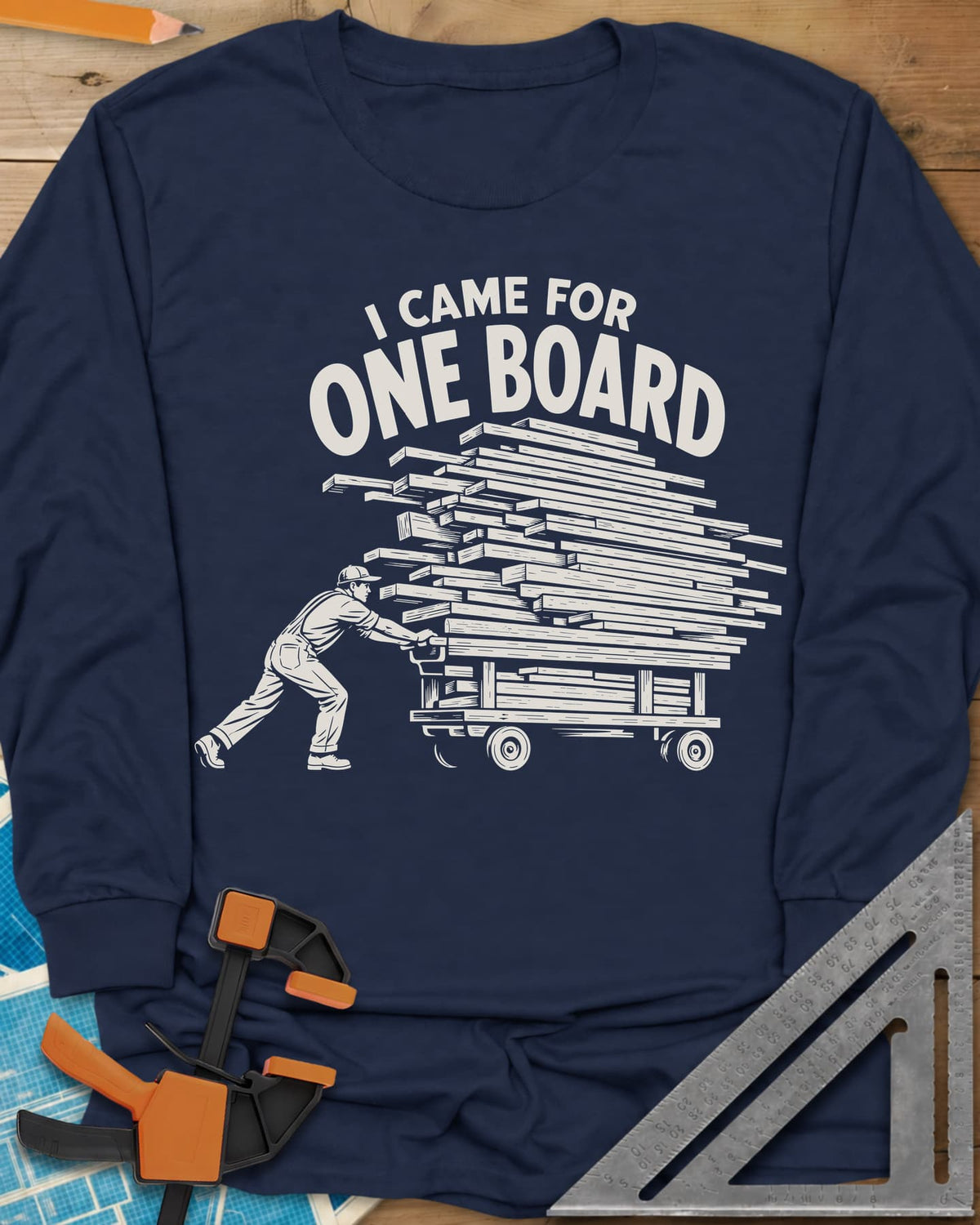 One Board Haul long sleeve shirt in Navy, a man pushing a flatbed cart piled high with lumber