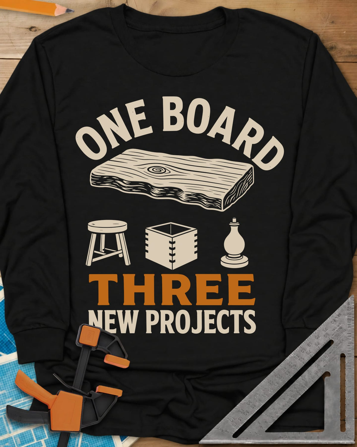 One Board long sleeve shirt in Black, a live-edge board over a stool, a box and a turned chess piece