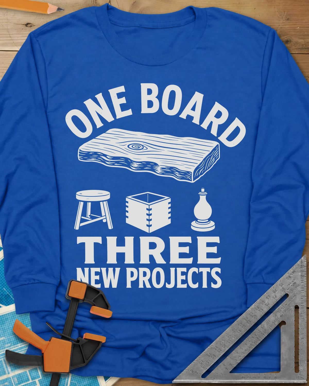 One Board long sleeve shirt in Royal, a live-edge board over a stool, a box and a turned chess piece