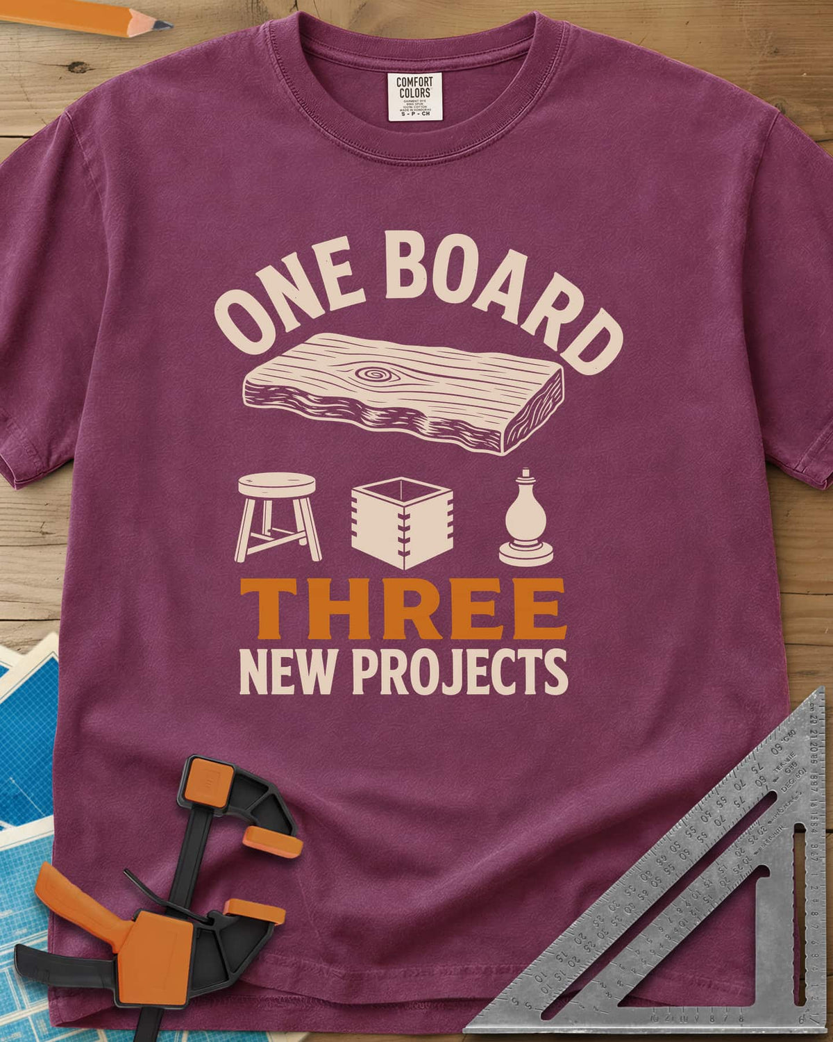 One Board heavyweight tee in Berry, a live-edge board over a stool, a box and a turned chess piece