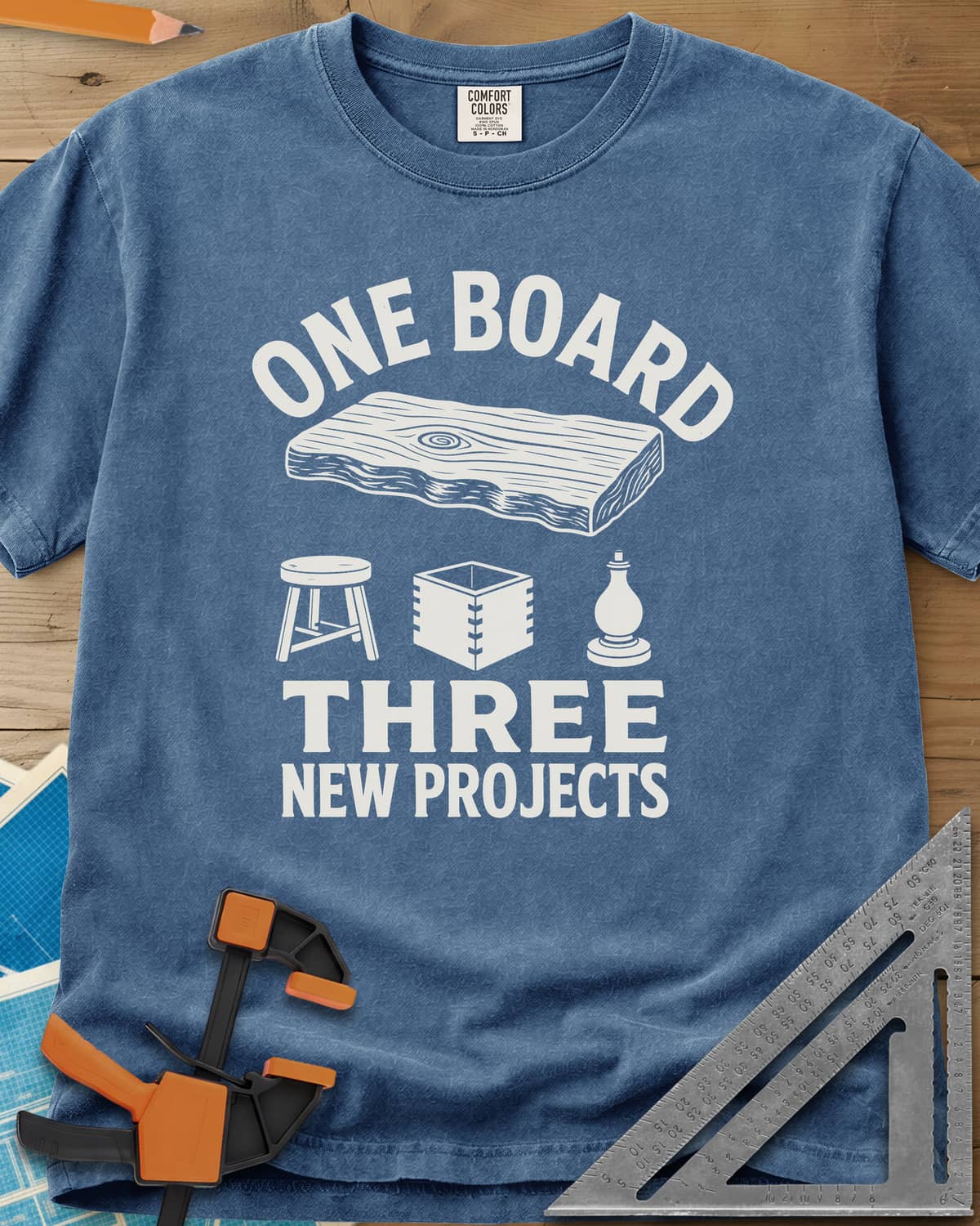 One Board heavyweight tee in Blue Jean, a live-edge board over a stool, a box and a turned chess piece