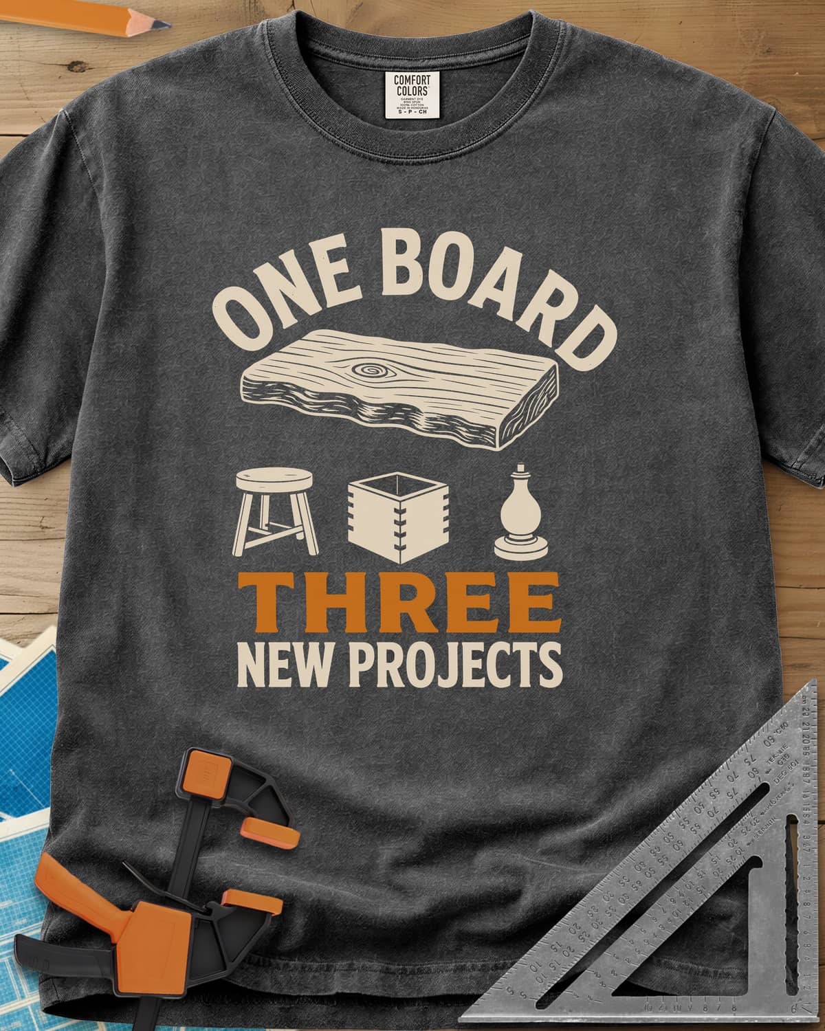 One Board heavyweight tee in Pepper, a live-edge board over a stool, a box and a turned chess piece