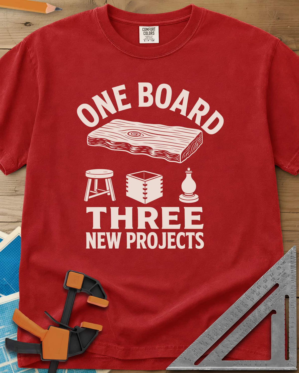 One Board heavyweight tee in Red, a live-edge board over a stool, a box and a turned chess piece