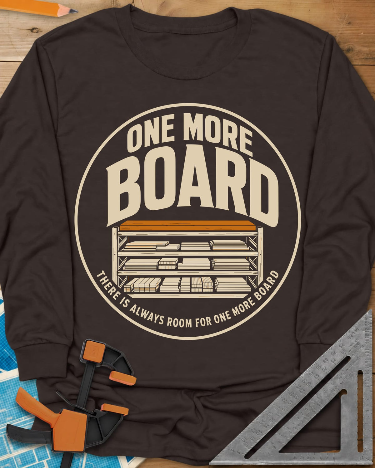 One More Board long sleeve shirt in Dark Chocolate, a round badge with a rack of stacked lumber