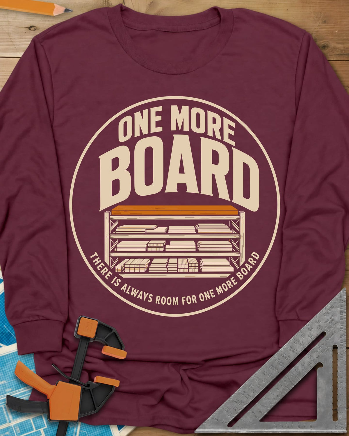 One More Board long sleeve shirt in Maroon, a round badge with a rack of stacked lumber