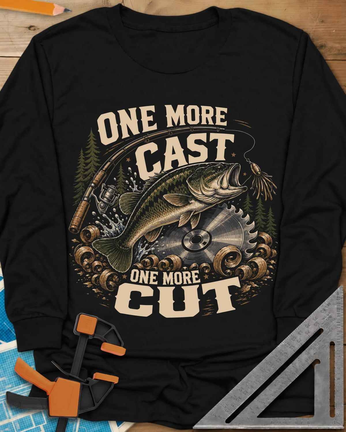 One More Cast One More Cut long sleeve shirt in Black, a leaping bass, saw blade, fishing rod and wood curls