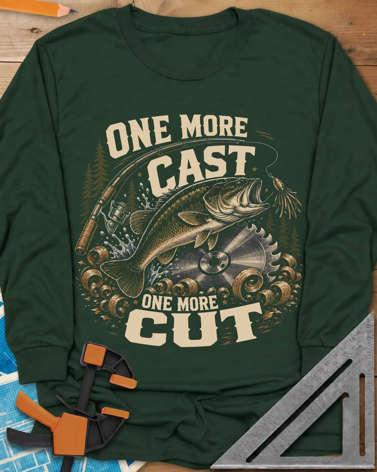 One More Cast One More Cut long sleeve shirt in Forest Green, a leaping bass, saw blade, fishing rod and wood curls