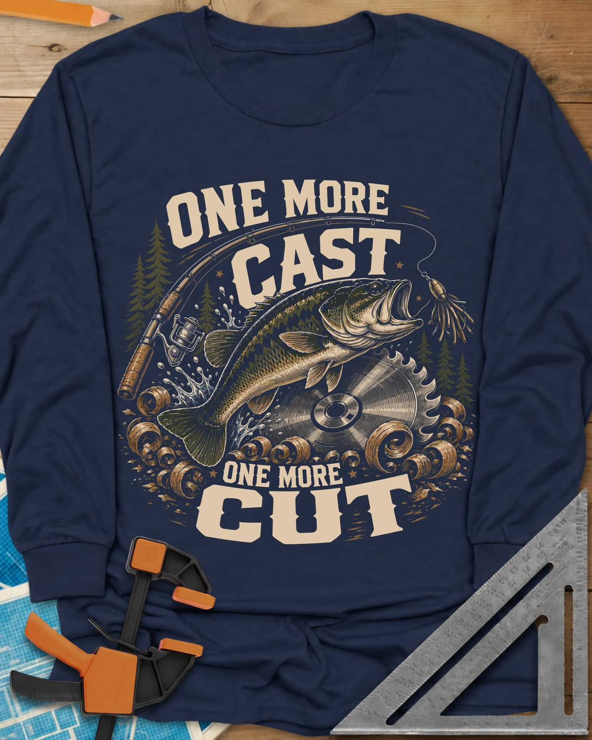 One More Cast One More Cut long sleeve shirt in Navy, a leaping bass, saw blade, fishing rod and wood curls