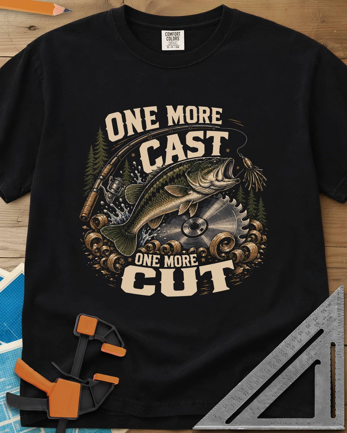 One More Cast One More Cut heavyweight tee in Black, a leaping bass, saw blade, fishing rod and wood curls