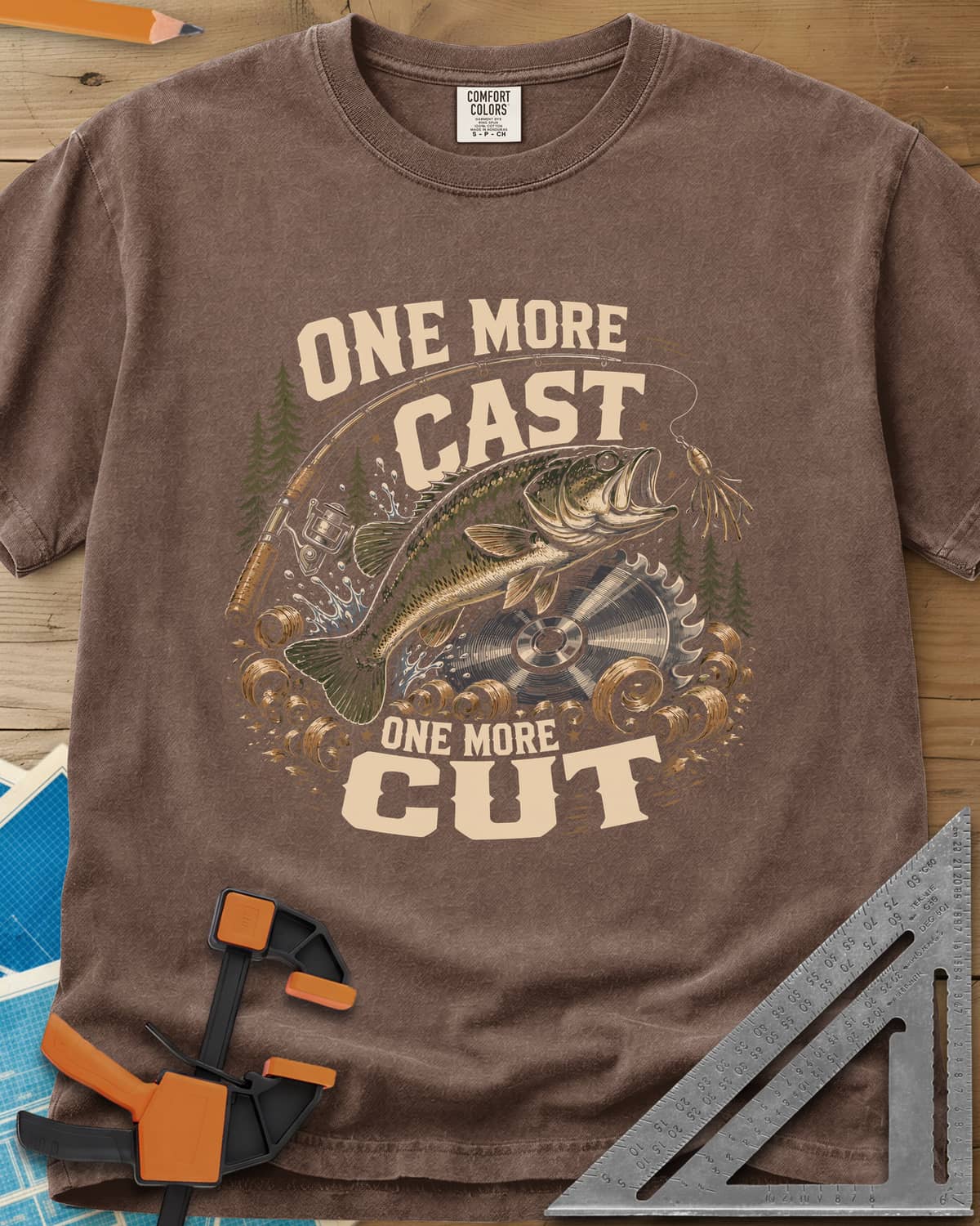 One More Cast One More Cut heavyweight tee in Espresso, a leaping bass, saw blade, fishing rod and wood curls