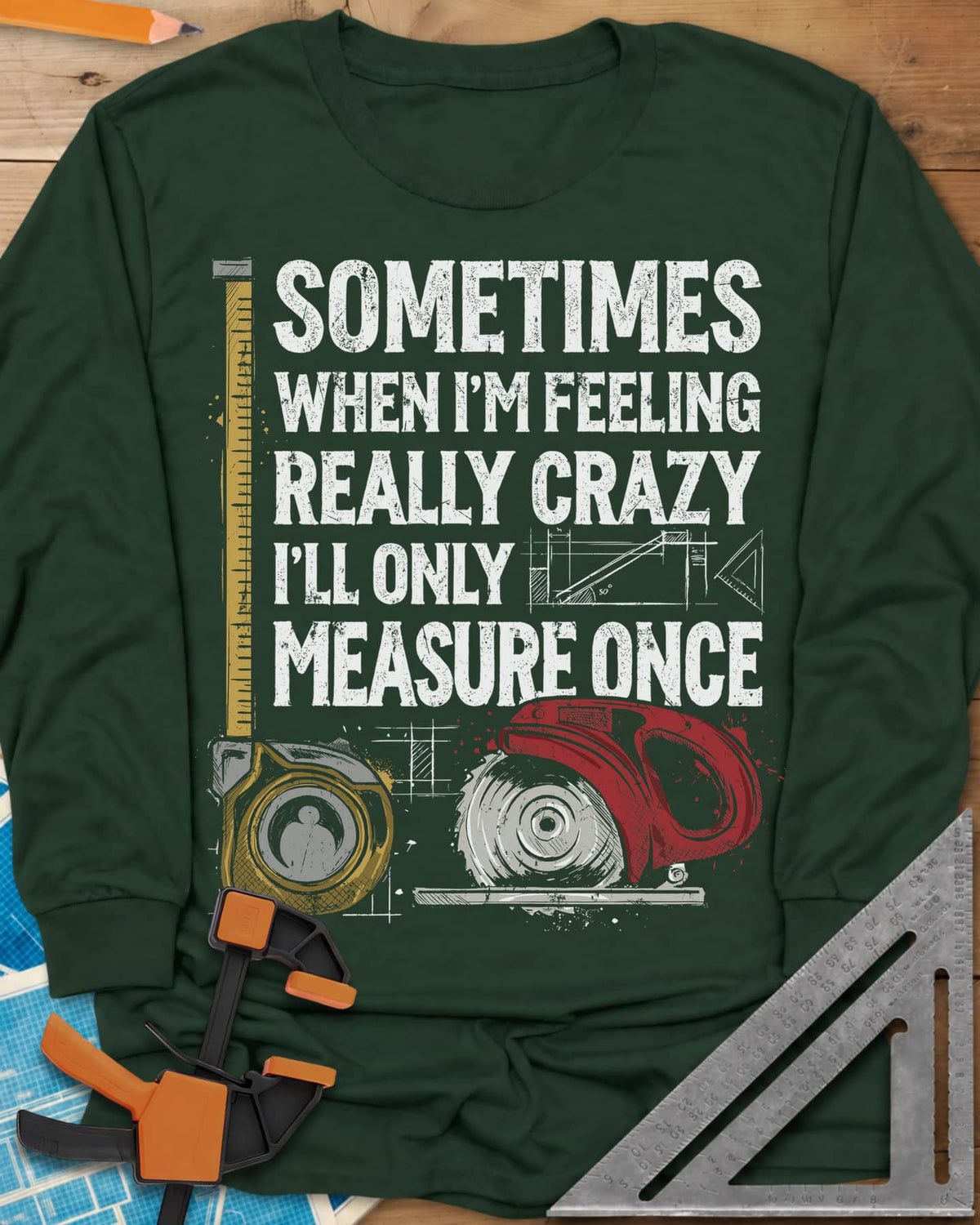 Only Measure Once long sleeve shirt in Forest Green, block letters with a yellow tape measure and a red circular saw