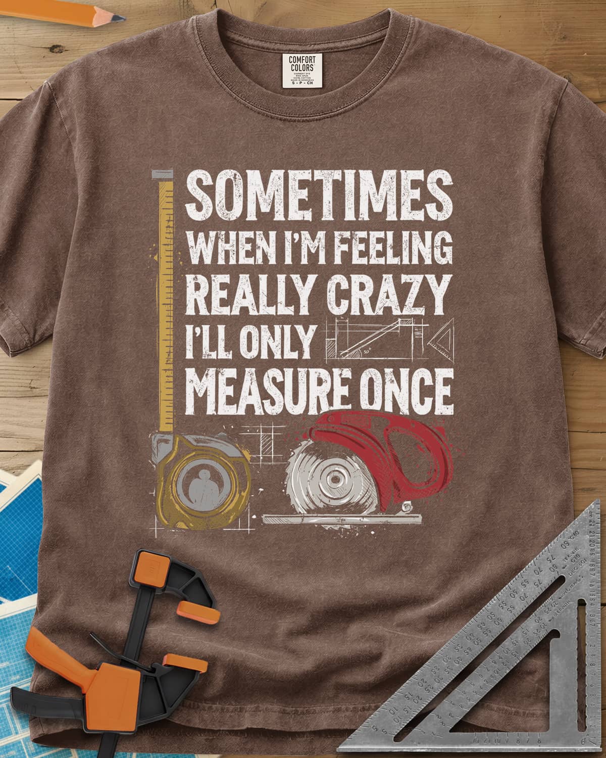 Only Measure Once heavyweight tee in Espresso, block letters with a yellow tape measure and a red circular saw