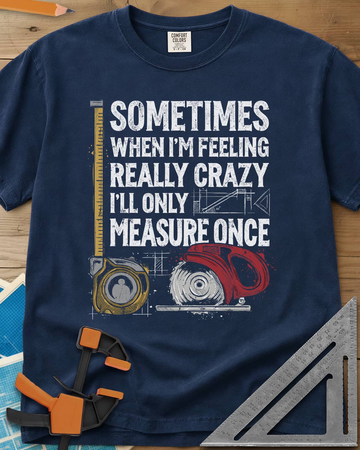 Only Measure Once heavyweight tee in Navy, block letters with a yellow tape measure and a red circular saw