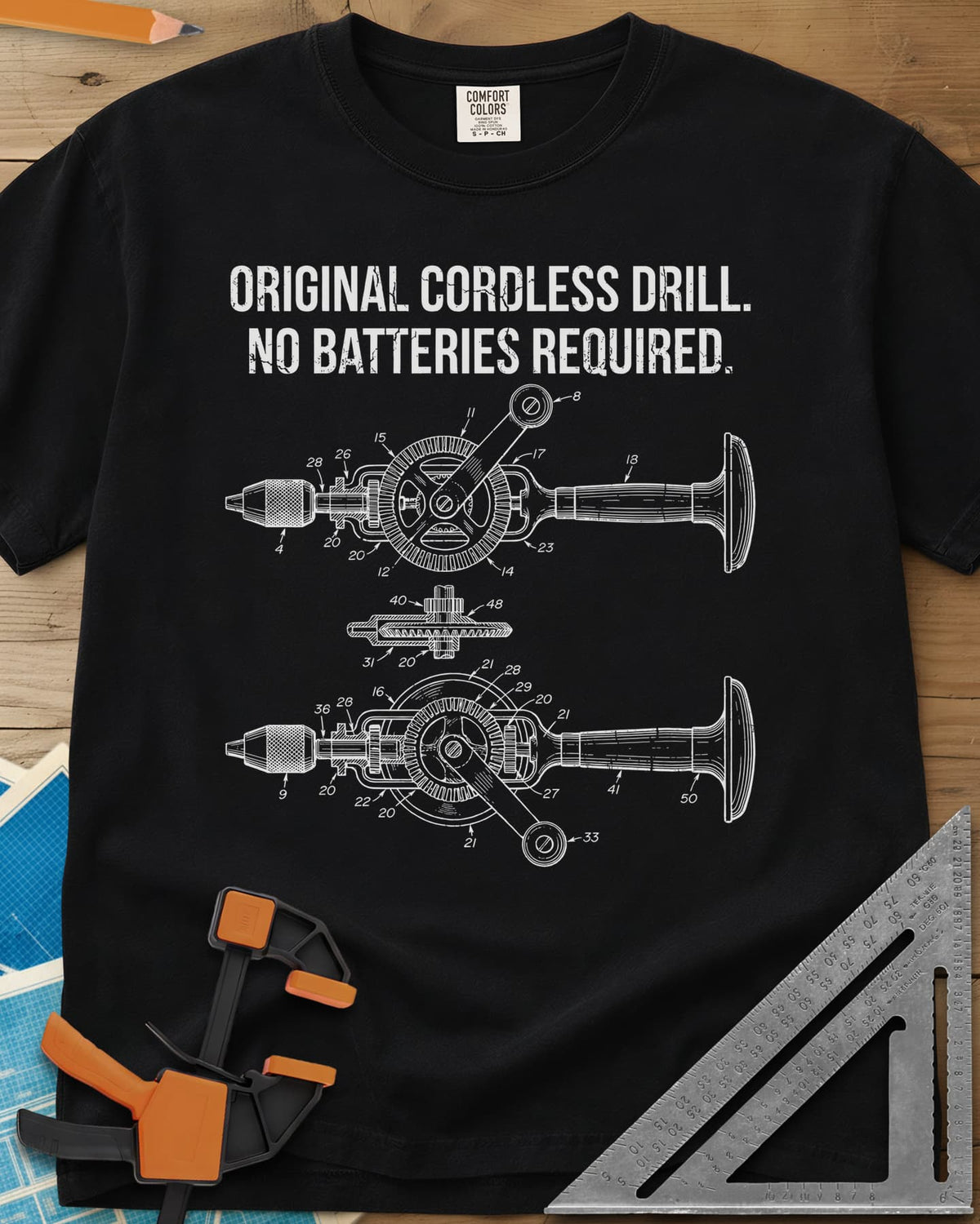 Original Cordless Drill heavyweight tee in Black, patent-style drawings of a hand-crank drill with numbered parts