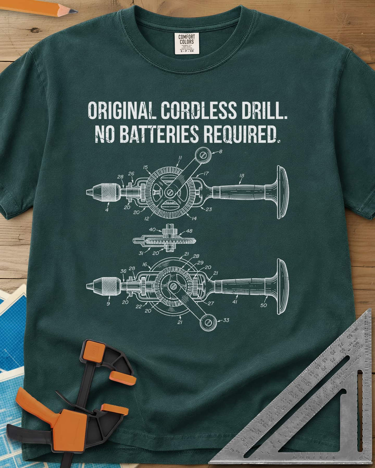Original Cordless Drill heavyweight tee in Blue Spruce, patent-style drawings of a hand-crank drill with numbered parts