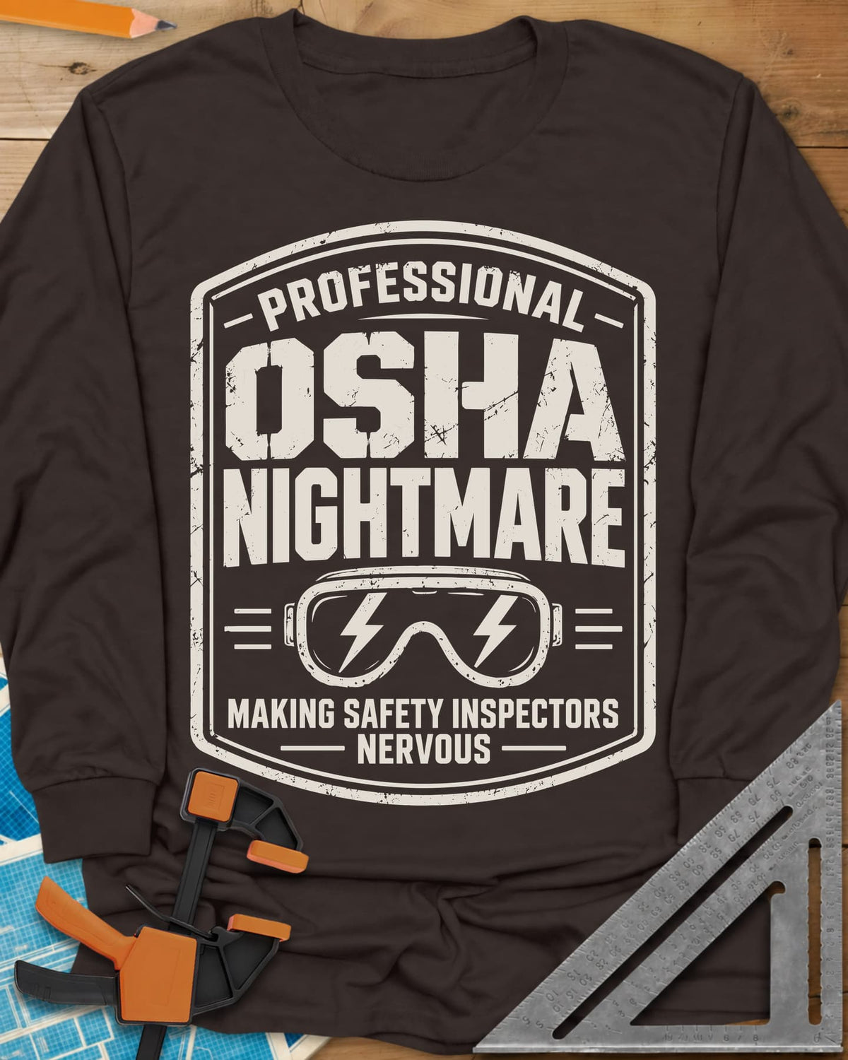 OSHA Nightmare long sleeve shirt in Dark Chocolate, a rugged badge with safety goggles and lightning bolts