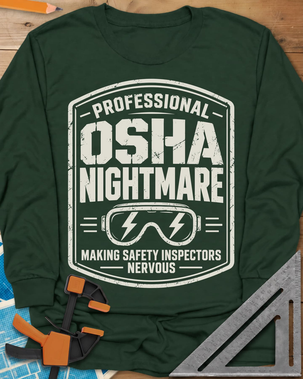 OSHA Nightmare long sleeve shirt in Forest Green, a rugged badge with safety goggles and lightning bolts