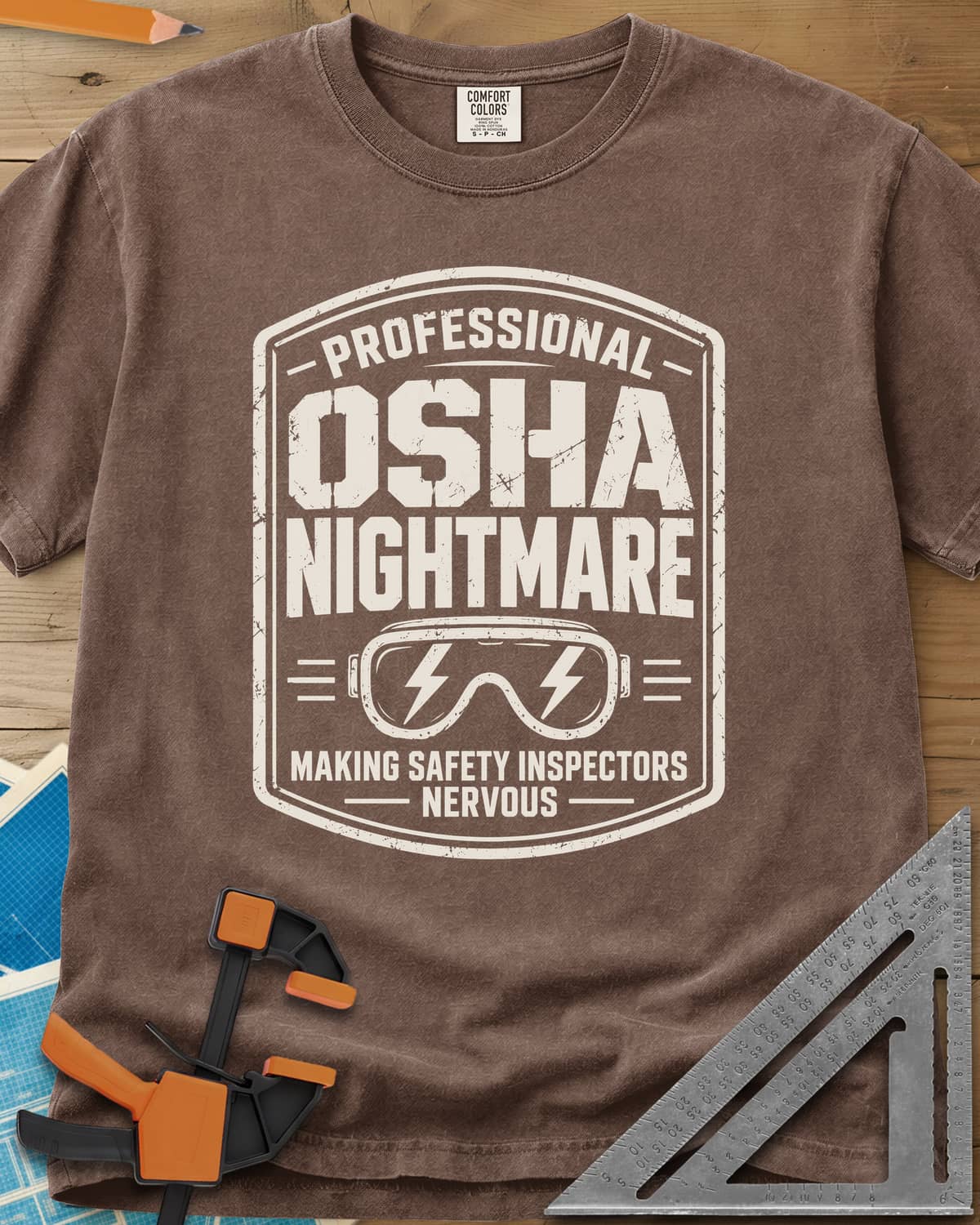 OSHA Nightmare heavyweight tee in Espresso, a rugged badge with safety goggles and lightning bolts