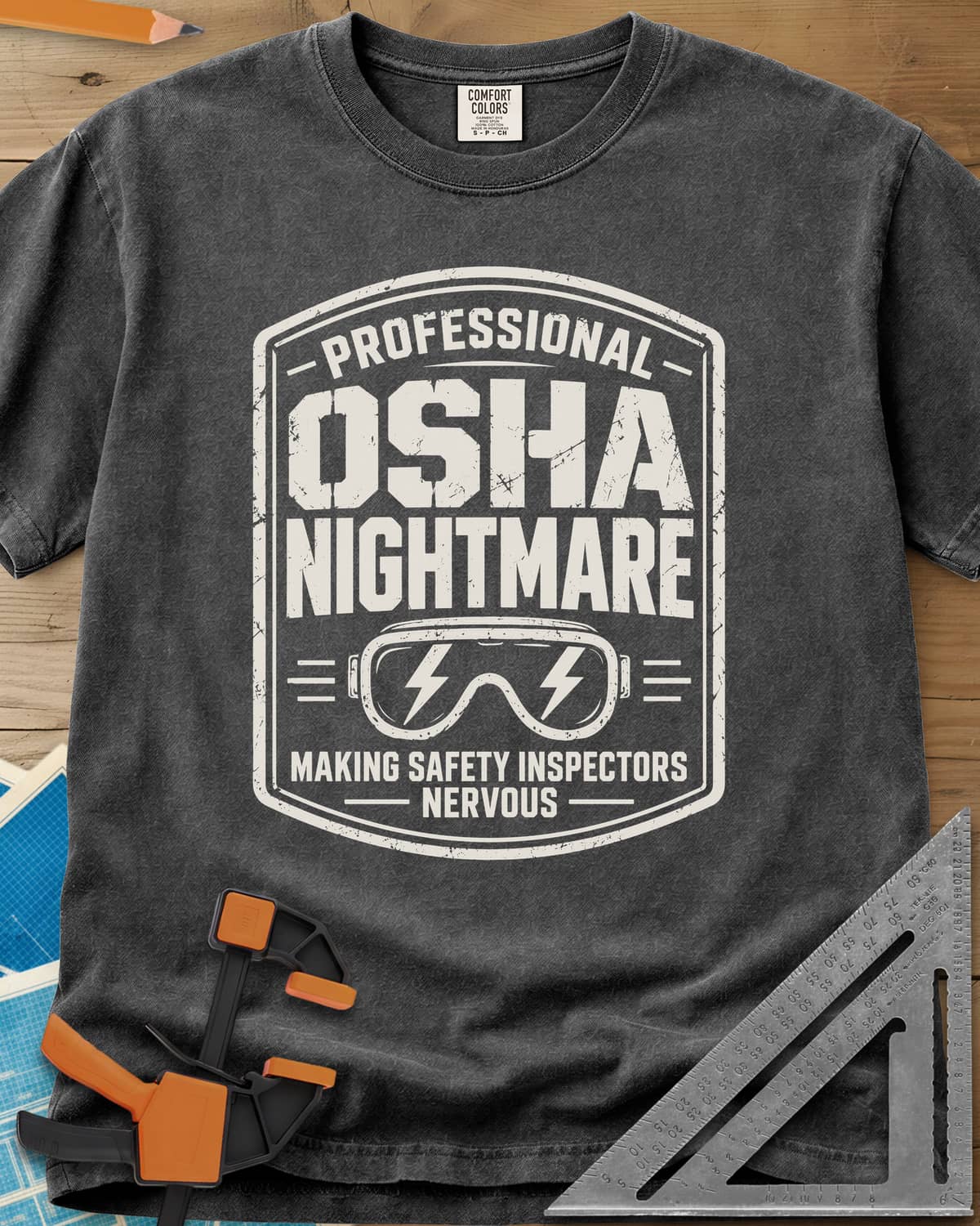 OSHA Nightmare heavyweight tee in Pepper, a rugged badge with safety goggles and lightning bolts