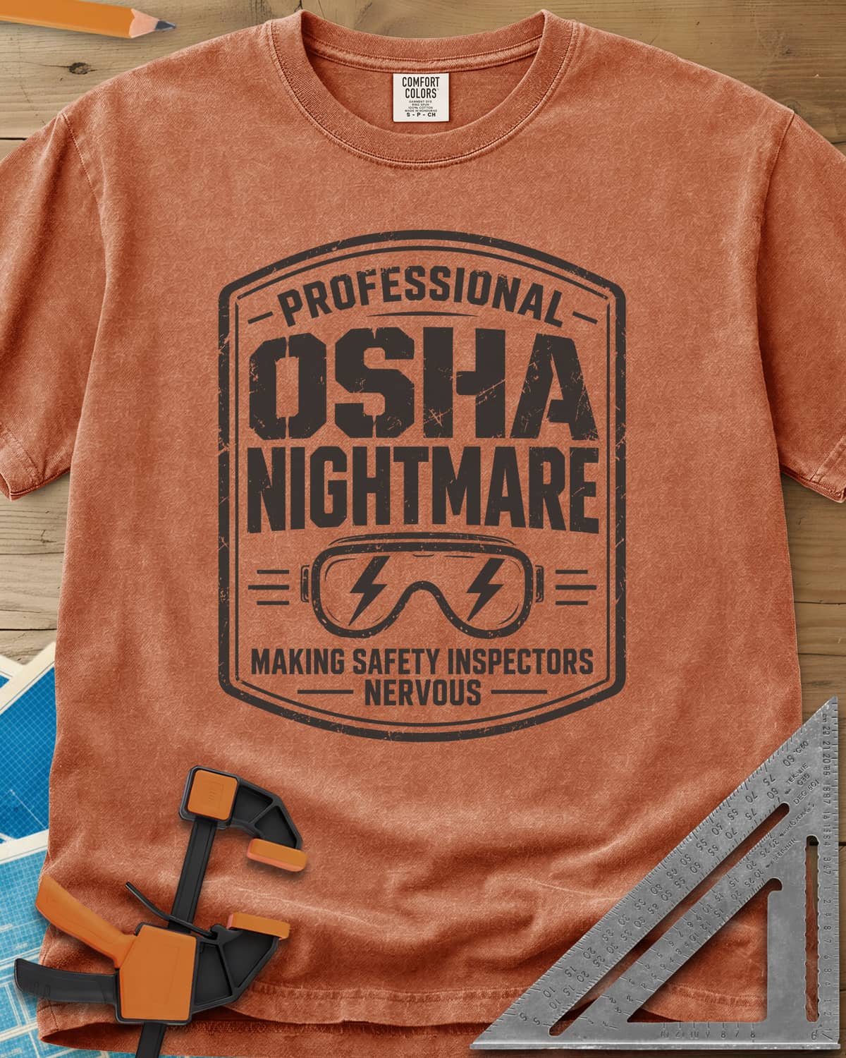 OSHA Nightmare heavyweight tee in Yam, a rugged badge with safety goggles and lightning bolts