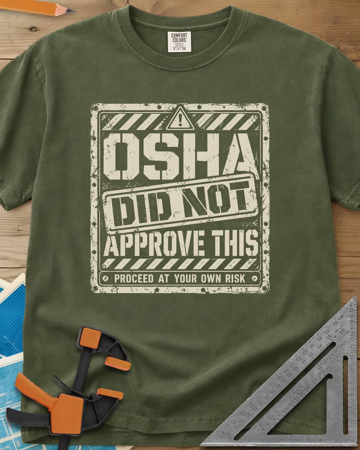 OSHA Not Approved heavyweight tee in Hemp, a worn warning sign with hazard stripes and a DID NOT stamp