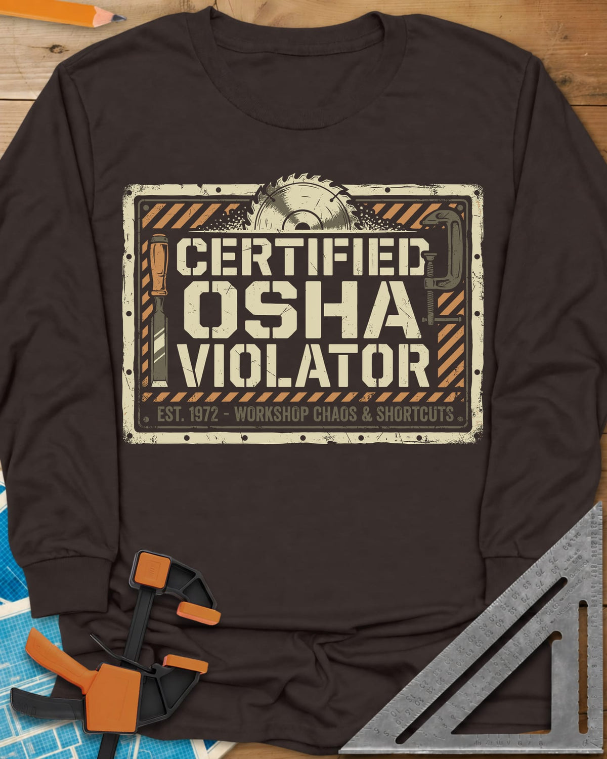 Osha Violator long sleeve shirt in Dark Chocolate, a hazard-striped warning sign with a saw blade, chisel and clamp
