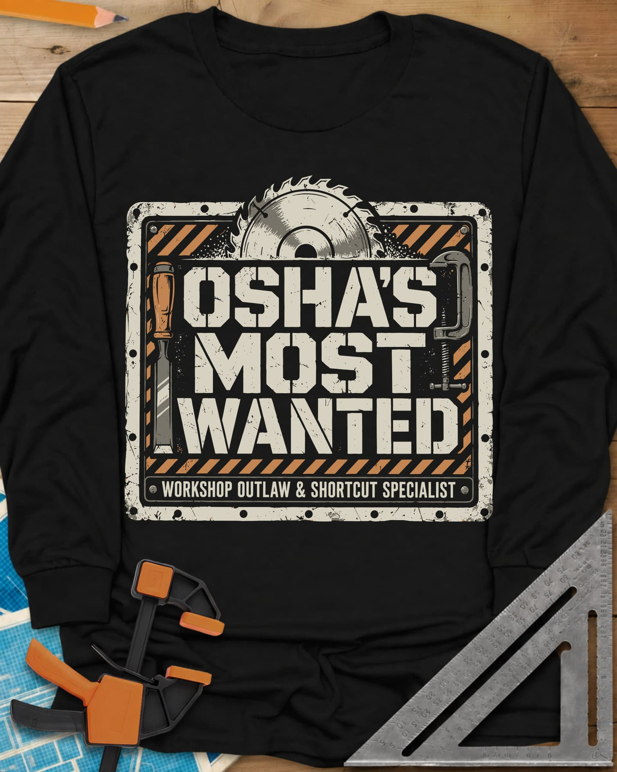 OSHA'S Most Wanted long sleeve shirt in Black, a saw blade, chisel and C-clamp around a hazard-striped plate