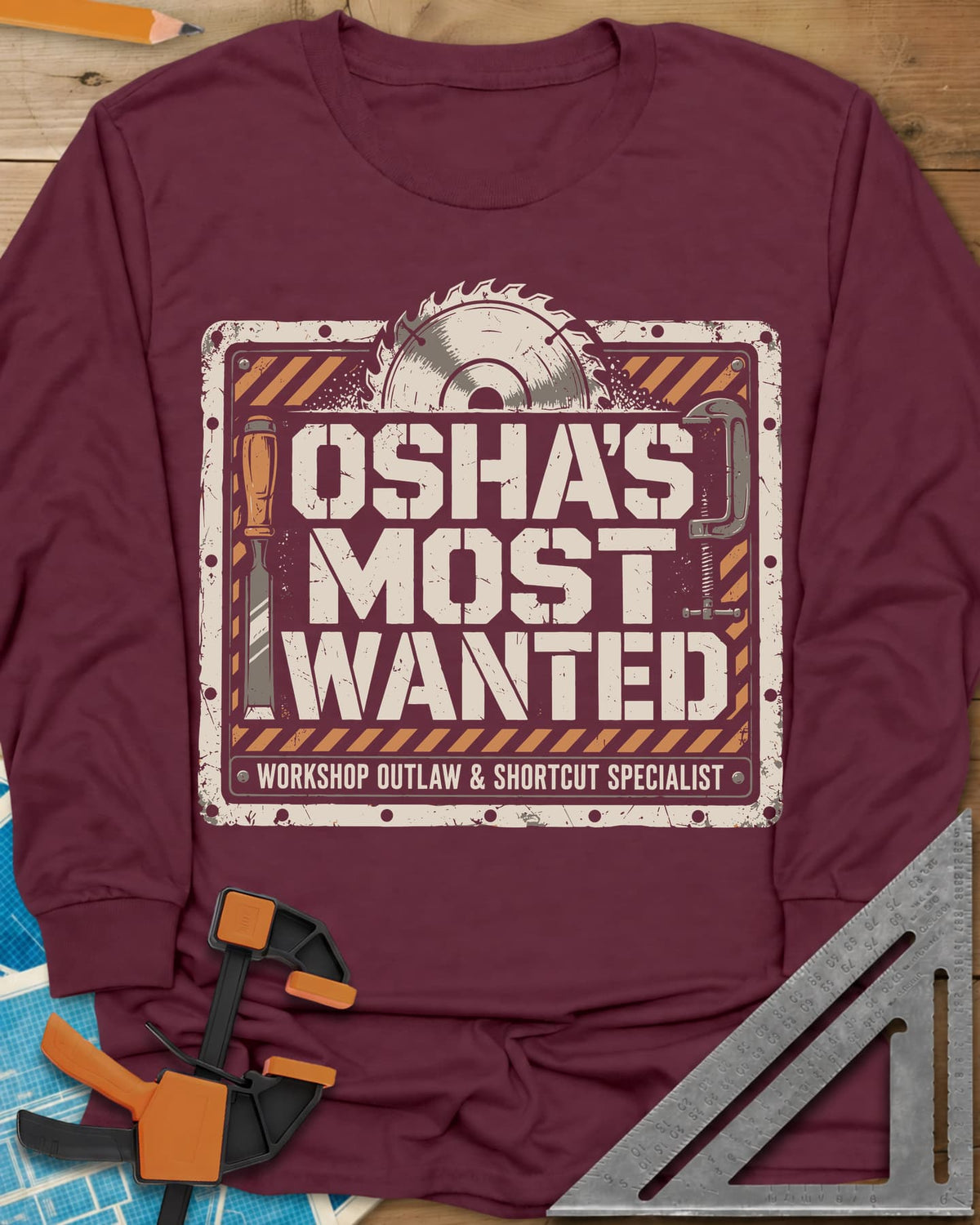 OSHA'S Most Wanted long sleeve shirt in Maroon, a saw blade, chisel and C-clamp around a hazard-striped plate