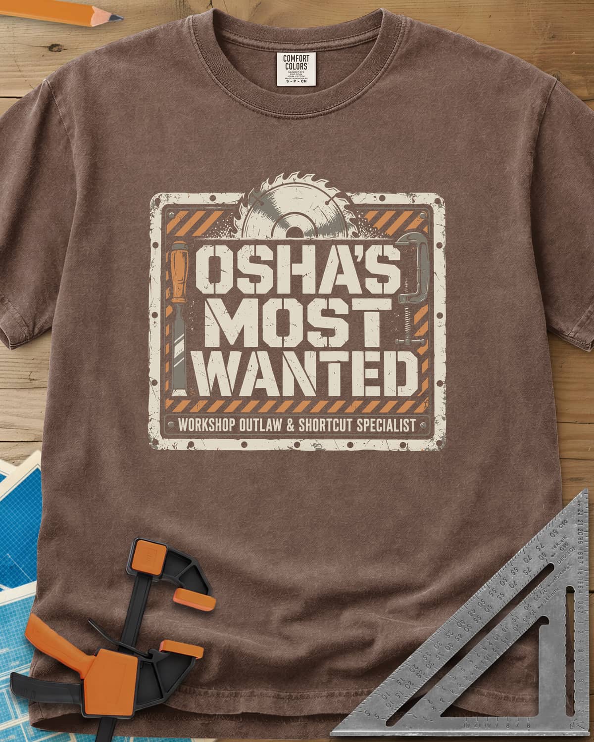 OSHA'S Most Wanted heavyweight tee in Espresso, a saw blade, chisel and C-clamp around a hazard-striped plate